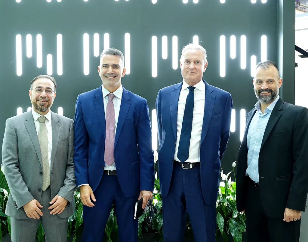 four men in suits seen in a group photograph