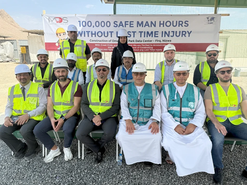 a group of men in a photograph wearing hi vis jackets and hard hats