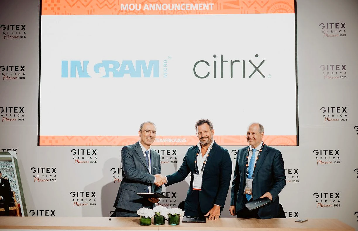 three men are seen at an event with two of them shaking hands
